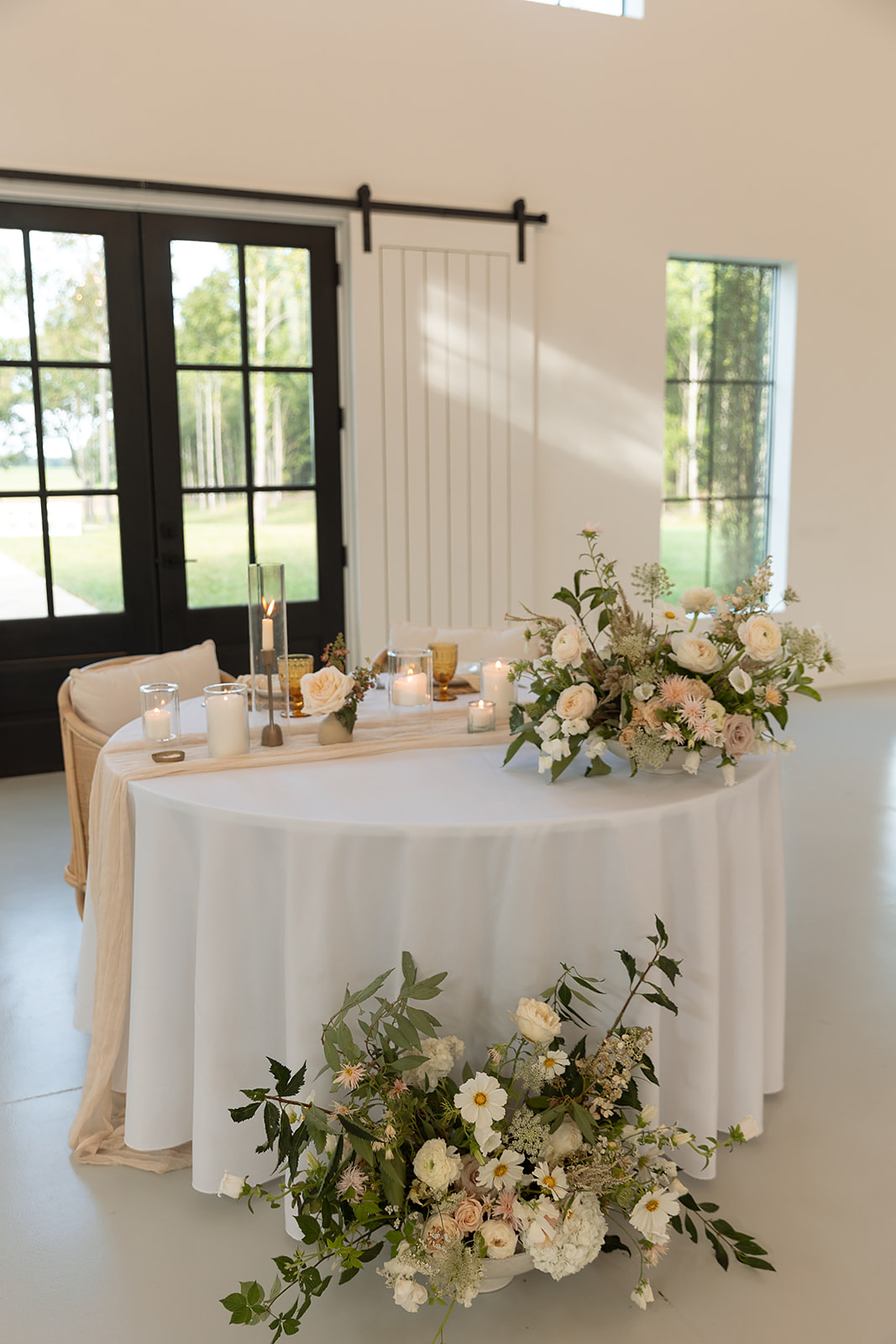 beautiful wedding decor on sweetheart table with flowers and romantic candles