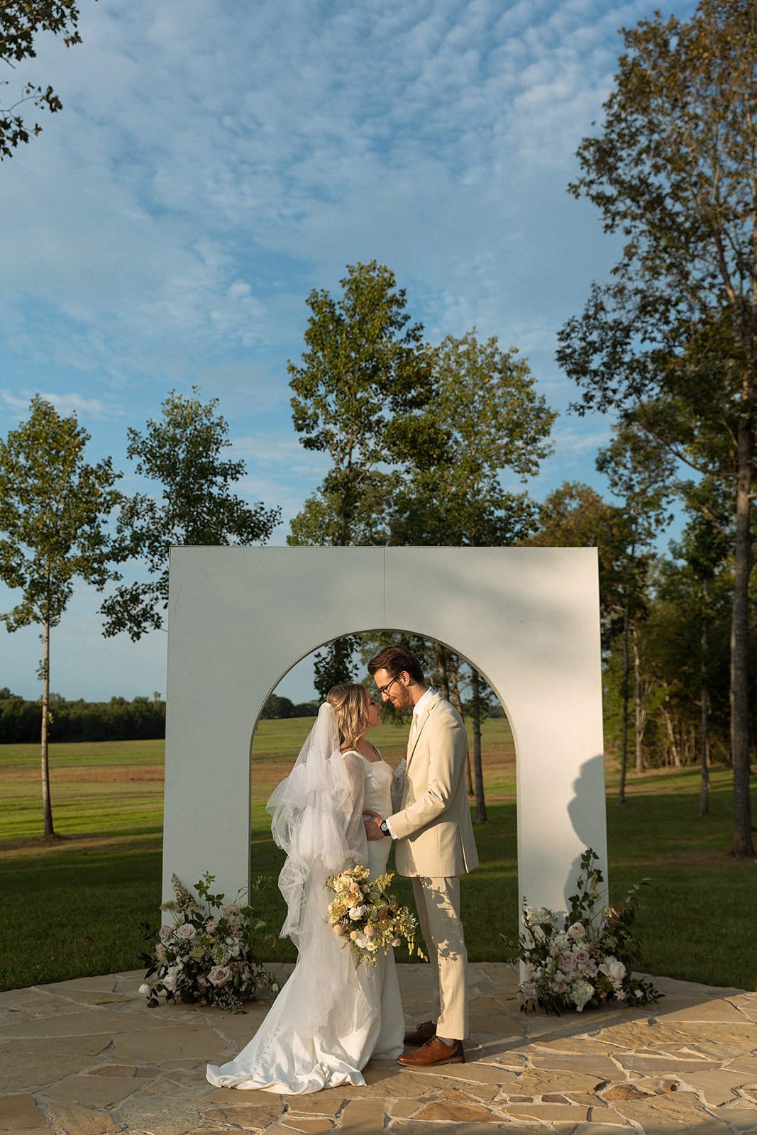 bride and groom outdoor tennessee wedding ceremony under arches, 2024 wedding design