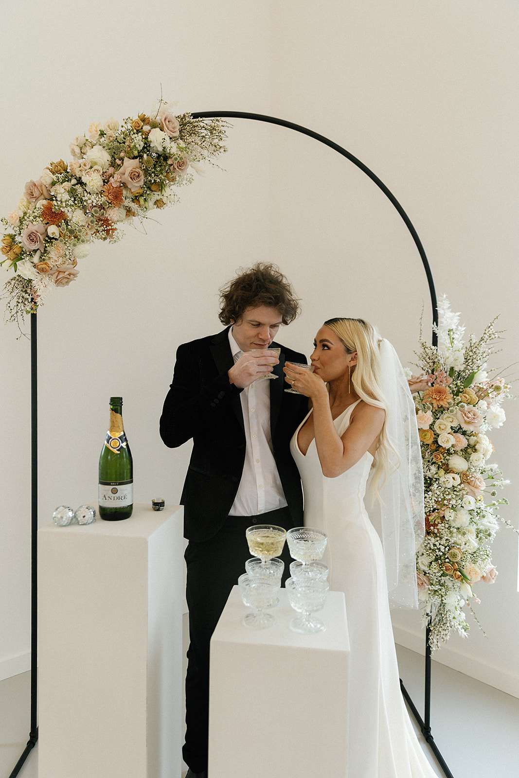 bride and groom enjoy champagne toast 