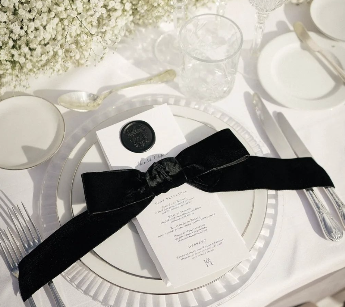 wedding tablescape featuring personalized bow on dinner menu