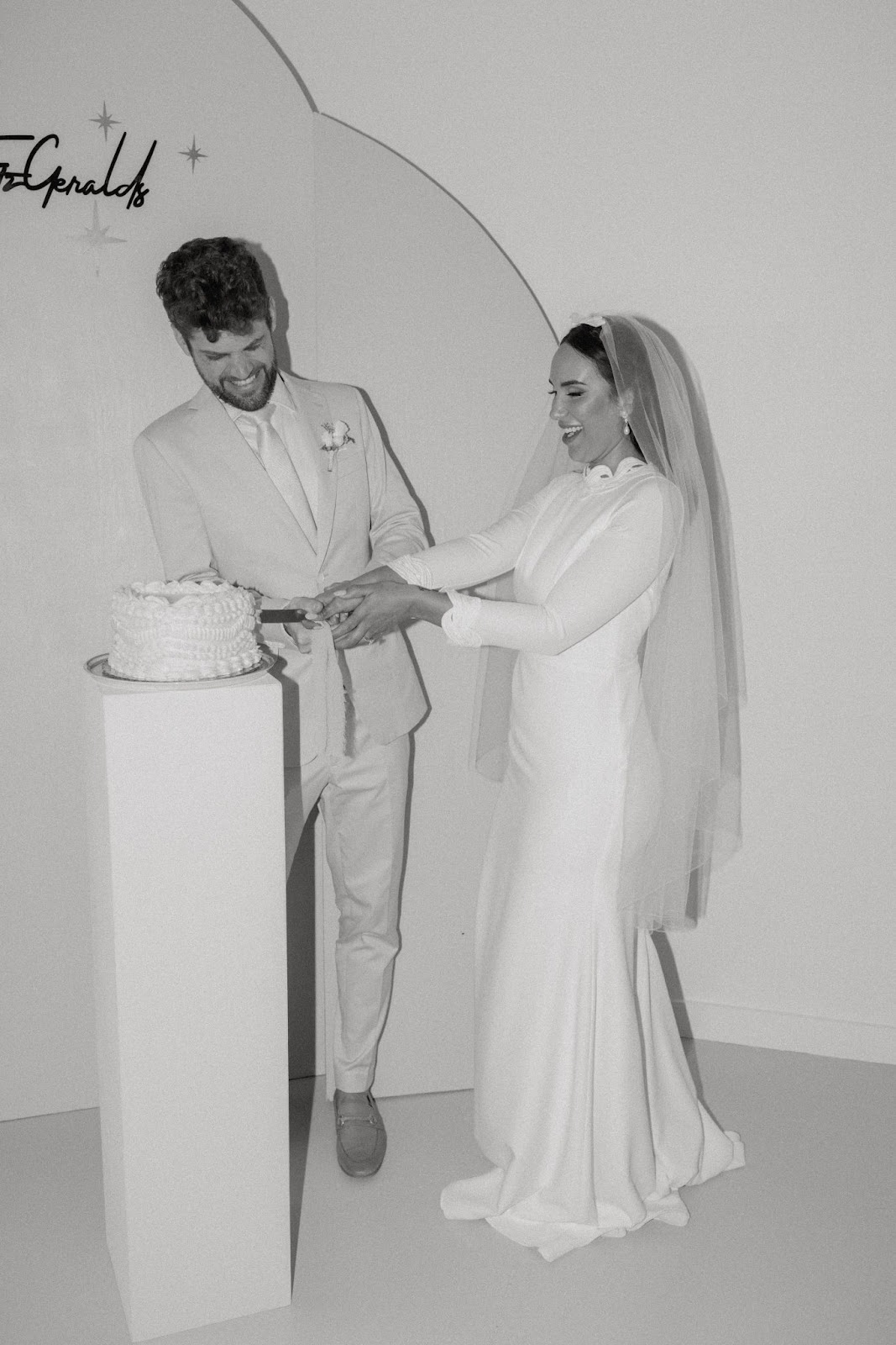 trendy vintage wedding cake being cut by bride and groom 