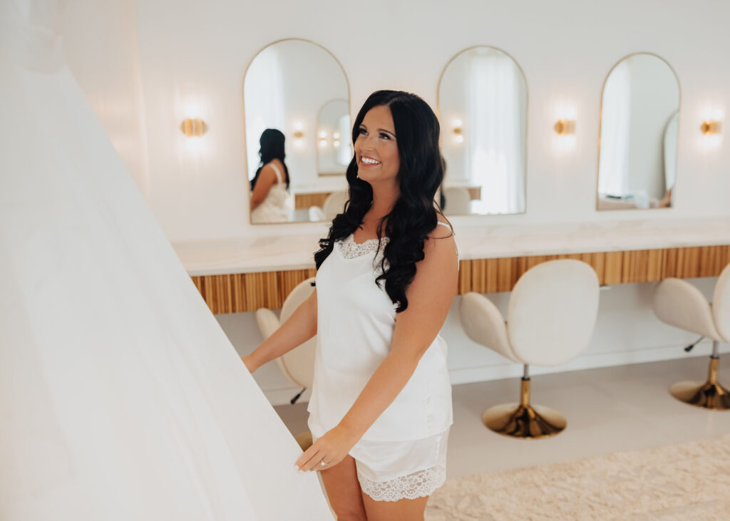 bride admiring dress at wedding venue