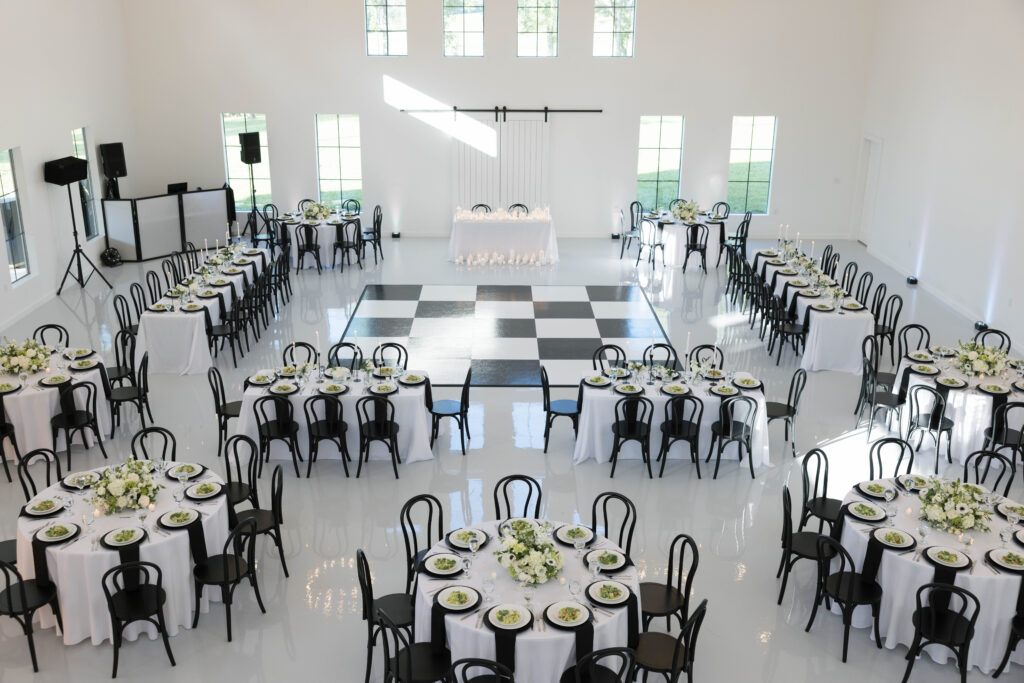 black chairs and dance floor in reception hall
